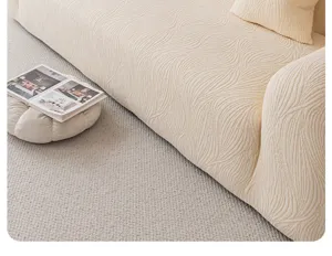 Detailed shot of beige jacquard plush sofa cover, elastic universal slipcover design for living room.