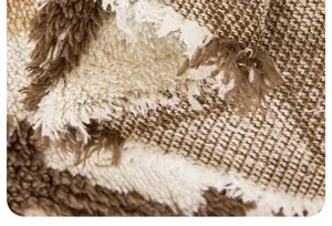 Plush sofa cover blanket fabric detail showing soft fuzzy texture and cozy brown white pattern