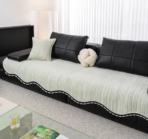 Detailed view of the light green striped ice silk sofa cover showcasing living room setting.
