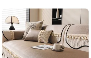 Detail view of ice silk sofa cushion cover with elegant tassels and minimalist black piping.