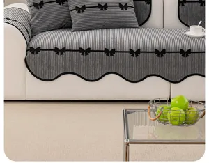 French chenille sofa cushion detail featuring grey stripes, black bows, and scalloped hem.