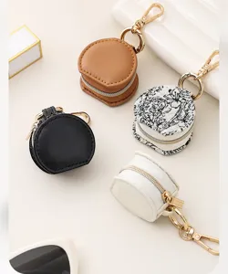 Mini round zipper jewelry storage pouch and bag pendant detail view, portable and stylish.