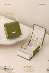 Portable green jewelry box storage case with ring slots and necklace hooks for travel.