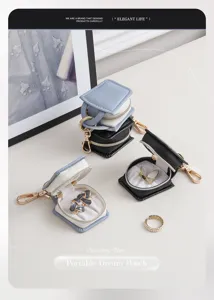 Mini portable book-shaped PU leather jewelry box with zipper and keychain for rings earrings.