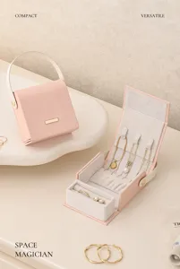 Compact portable jewelry box with pink PU leather, velvet lining, ring slots and necklace hooks.