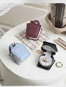 Mini portable jewelry box handbag shape travel ring earring storage case with keychain hook.