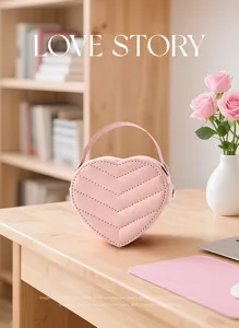 Pink heart-shaped jewelry box with handle, cute PU leather storage case for rings and gifts.