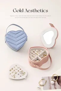 Detail view of heart-shaped portable jewelry storage box with mirror and velvet interior.