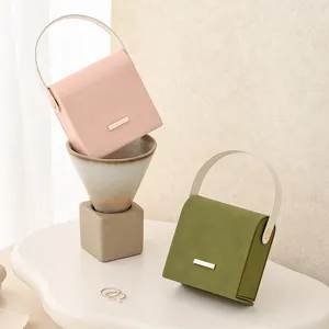 Portable mini jewelry box organizer with handle, stylish travel storage case for rings and earrings.
