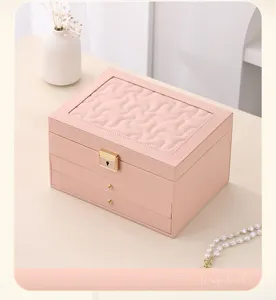 Pink leather multi-layer jewelry box with drawers, elegant storage for rings and necklaces.