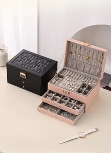 Detailed view of large capacity multi-layer leather jewelry box with drawers for rings and necklaces.