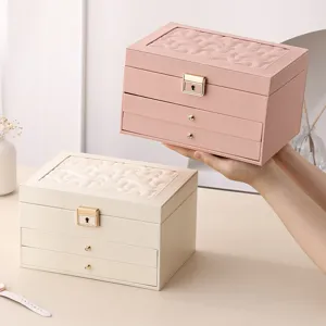 Multifunctional leather jewelry box with multi-layer drawers, large capacity for rings and necklaces.