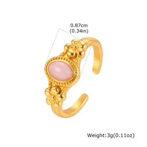 Gold stainless steel open ring detail featuring a natural pink crystal stone and sweet flowers.