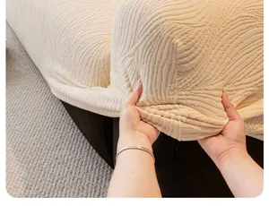 Close-up of beige jacquard plush sofa cover, showing stretchable fabric and fit detail.