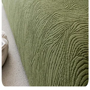 Close-up of green jacquard plush sofa cover texture, showing soft and elastic fabric details.