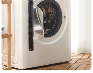 Detailed shot of front load washing machine drum interior and clean home laundry room scene setup.