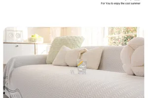 Detail shot of the cool summer sofa cover in grey zig-zag pattern, styled on a cozy living room couch.