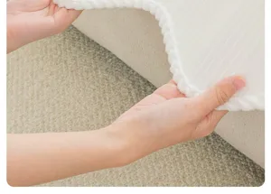 White plush sofa cushion fabric texture detail close-up view showing soft material.