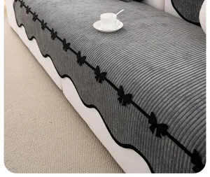 French chenille sofa cushion detail showing textured grey fabric and elegant black bow design.