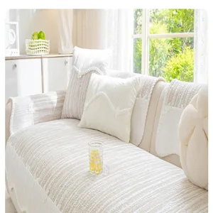Detail shot of beige striped ice silk sofa cushion cover in a bright living room scene.