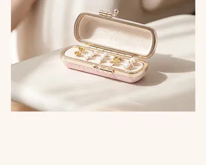 Detailed close-up of the portable jewelry box interior, showcasing the soft lining and stud earrings.