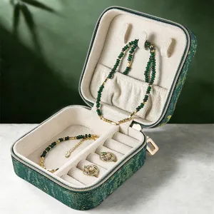 Green retro portable travel jewelry box, velvet lined storage case for daily accessories.