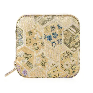 Golden retro brocade travel jewelry box portable small storage case for rings and earrings.