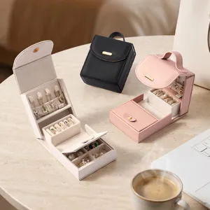 Portable travel jewelry box leather small storage case for rings necklaces earrings display.