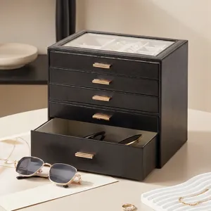 Multi-layer black jewelry box with clear glass top, drawer storage and gold handles for gifts.