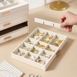 Multi-layer PU leather jewelry box with drawers and adjustable dividers for rings and earrings.