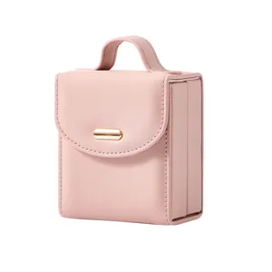 Portable travel pink jewelry box with handle and gold clasp for rings necklaces earrings.