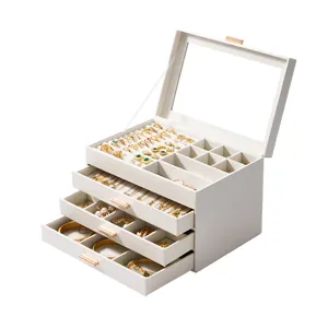 White 4-layer glass lid jewelry box with drawers for rings, necklaces, and bracelets.