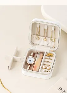Portable marble pattern jewelry box with multi-functional compartments and soft velvet lining.