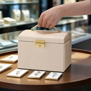 Elegant beige PU leather jewelry box with lock, multi-layer storage case for rings and necklaces.