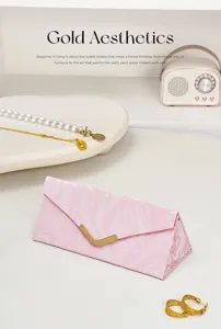 Detailed view of pink marble foldable glasses case and jewelry storage box in elegant scene.