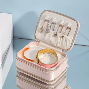 Double layer pink portable jewelry box with zipper, mirror, and multi-functional storage.