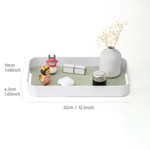 Nordic style plastic leather storage tray with green mat for home living room organization.
