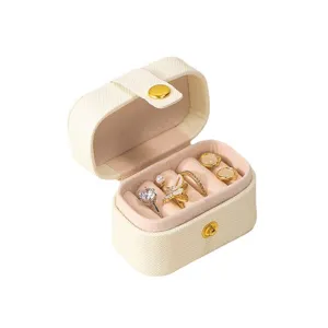 Compact portable mini jewelry storage box with soft velvet lining for rings and earrings.