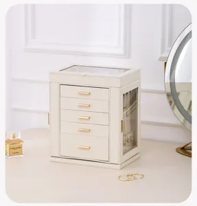 Vue détaillée de la boîte de rangement bijoux multicouche avec fenêtre en verre et tiroirs.