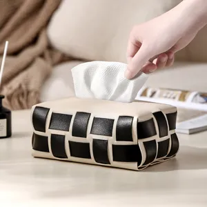 Detailed view of the luxury woven leather tissue box in a cozy home living room setting.