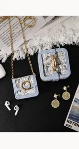 Detailed view of the vintage embroidered mini headphone bag and square pouch with gold hardware.