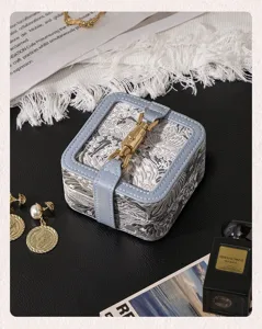 Detailed close-up view showcasing the vintage jacquard fabric and leather edge of the box.