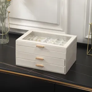 Beige leather multi-layer jewelry box with glass lid, clear storage for rings and earrings.