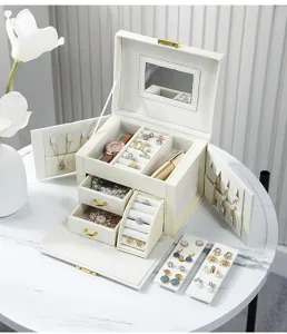 Large capacity white leather jewelry box with multi-layer drawers, mirror and ring slots.