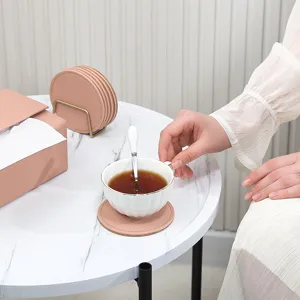 Pink leather cork coasters set with metal holder for table protection home dining use.