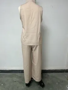 Back view detail of women sleeveless vest and long trousers set in light beige, plain design.