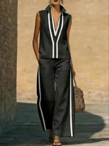 Detailed view of women's black and white contrast sleeveless top and pants set outdoors.