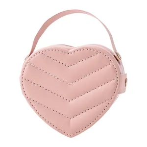 Pink heart-shaped leather jewelry box with top handle and chevron stitching for gifts.