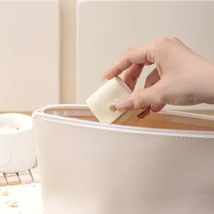 Portable microfiber travel jewelry pouch for rings and necklaces, beige minimalist storage bag.