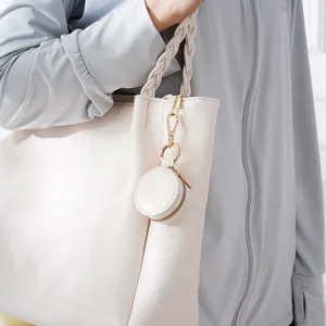 Mini round white jewelry box bag pendant, portable ring and earring storage case detail view.